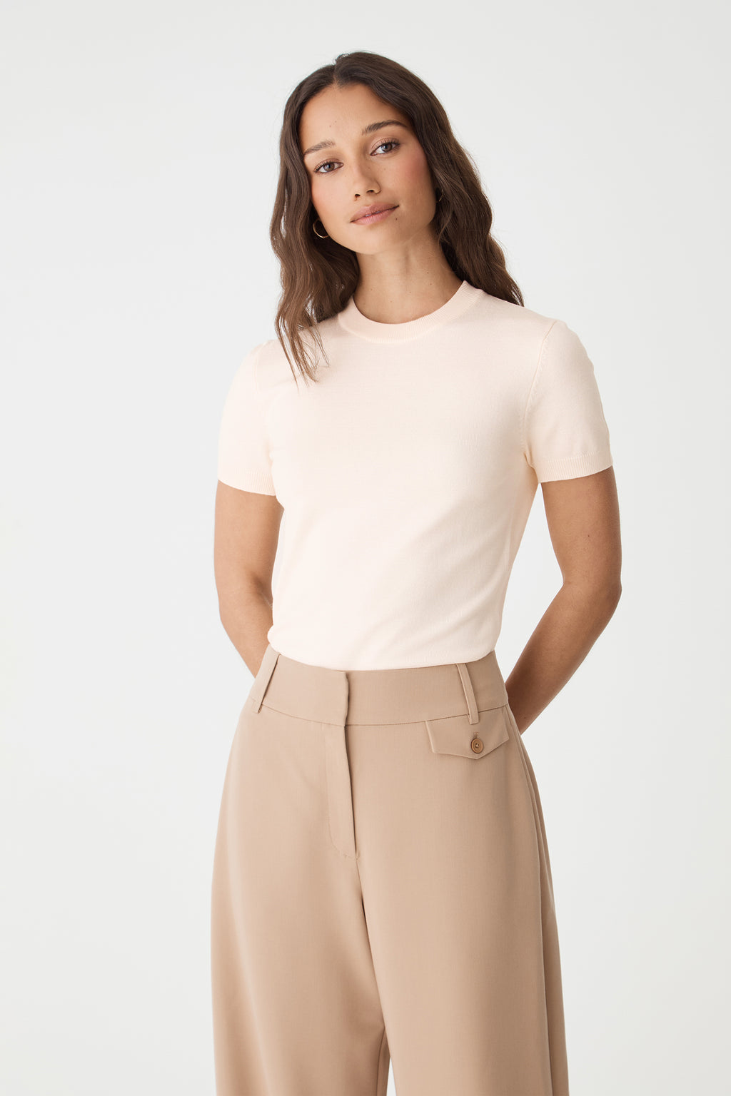 Close-up front view of the Alabaster knit top showing crew neckline and ribbed edges