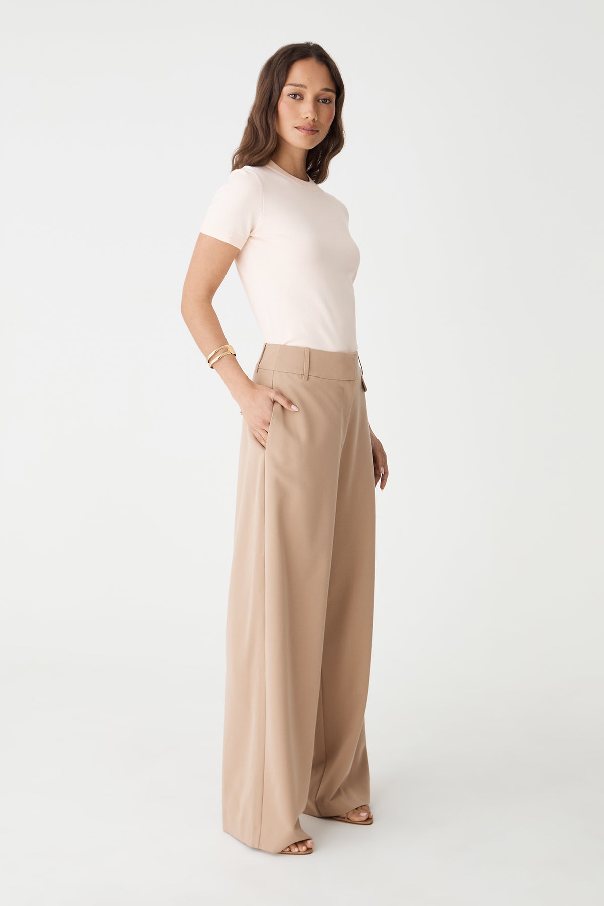 Side view of the Alabaster knit top with beige wide-leg trousers