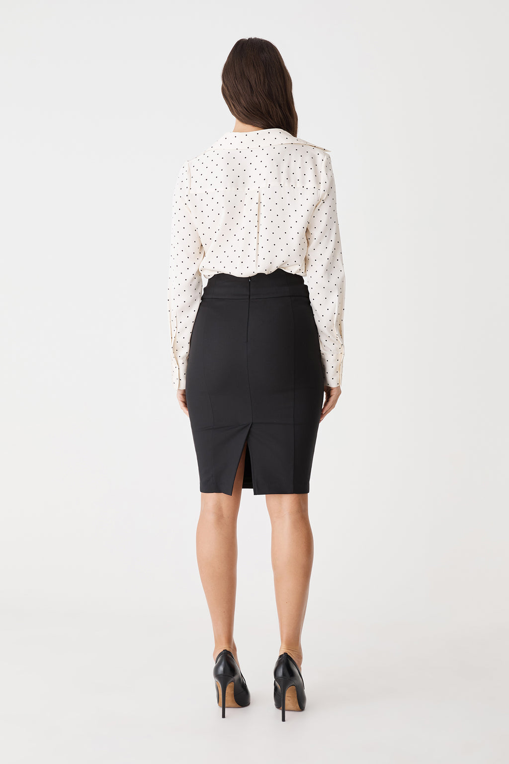 Back view showing centre back zipper and back vent of the black Safira Pencil Skirt