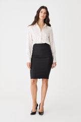 Safira Pencil Skirt in black, front view worn with a cream spotted blouse and black heels
