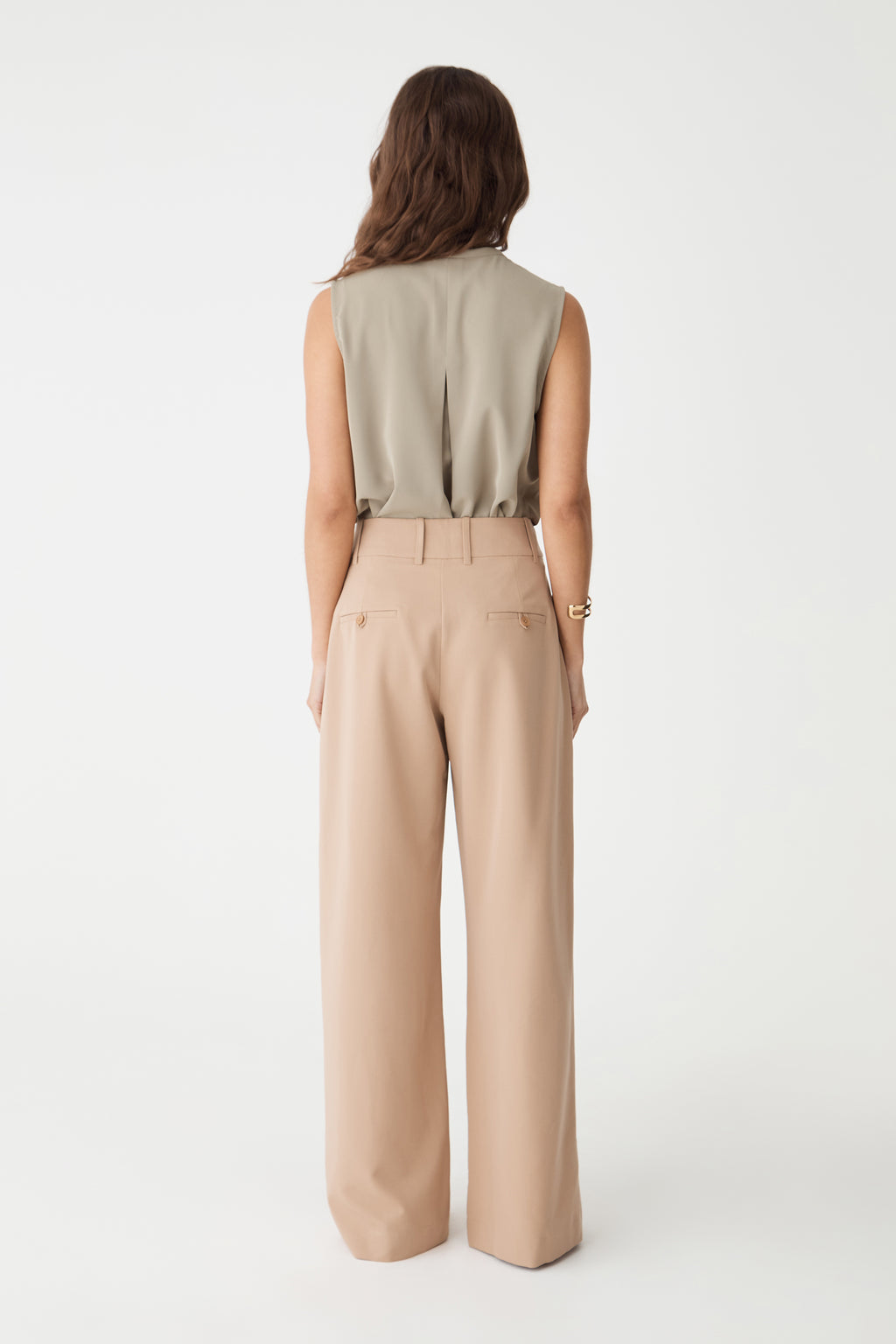 Back view of the khaki Alivia 2 V-Neck Top showing back tuck detail