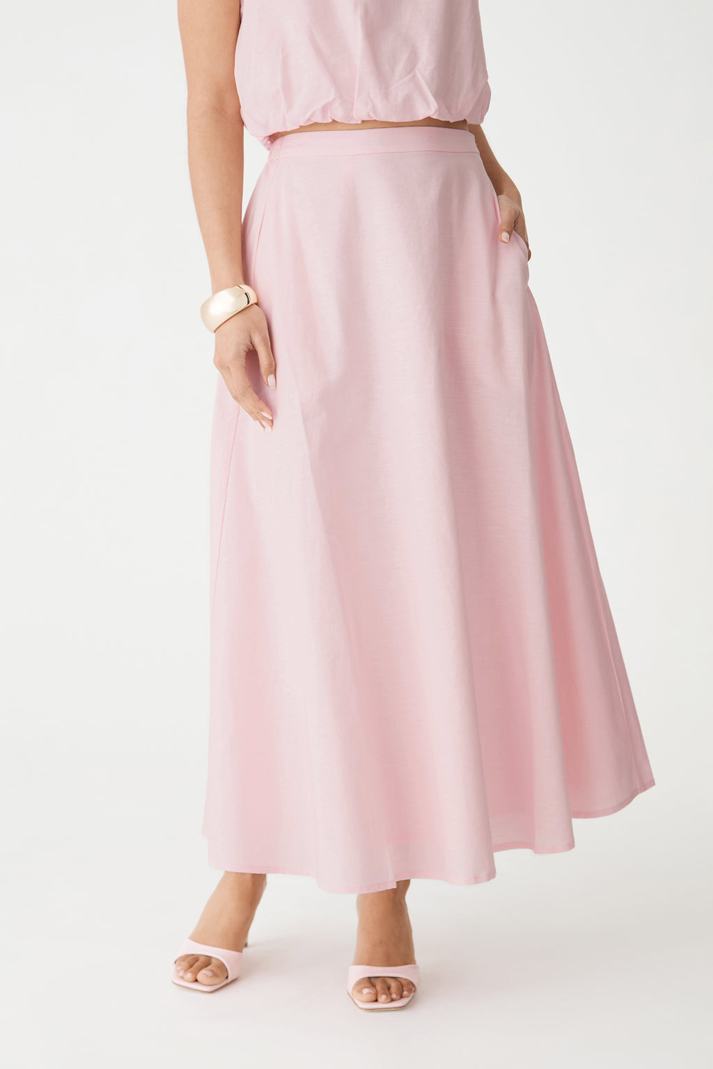 Close-up front view of the A-line midi skirt showing high waist and side pocket