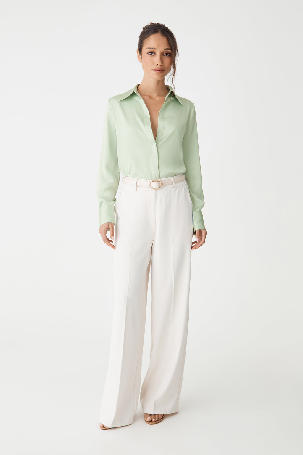 Mae Satin Shirt in mint, front view worn tucked into cream wide-leg trousers with belt