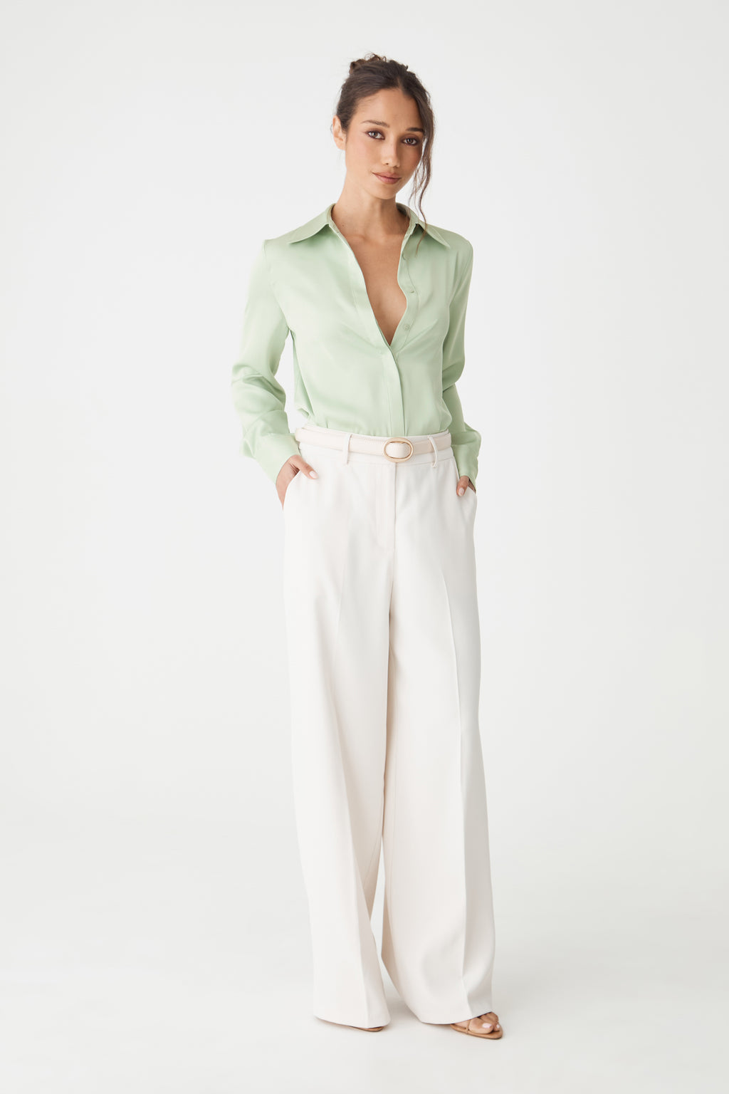 Full-length front view of the mint Mae Satin Shirt with cream wide-leg trousers