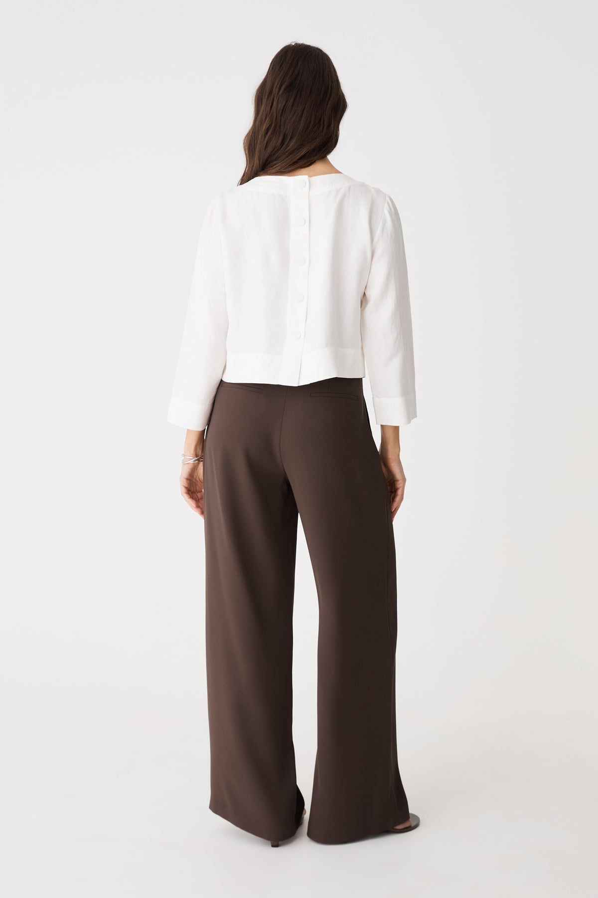 Back view showing back waist darts and double faux welt pockets