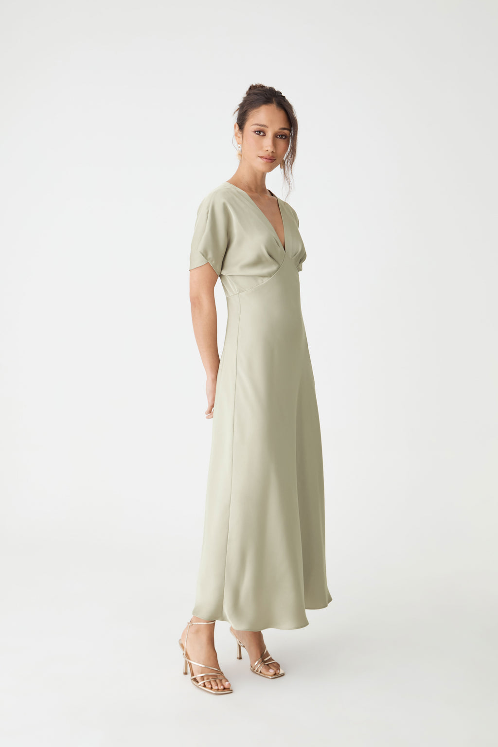 Side view of the sage Catalina V-Neck Satin Dress showing invisible side zip and skirt drape