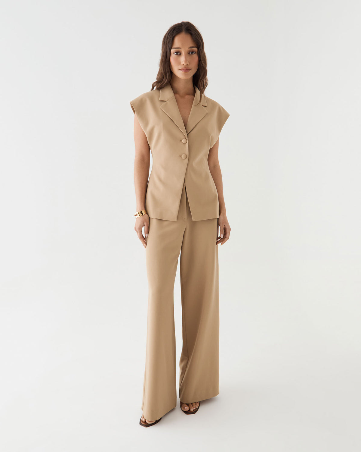 Side-front view of the camel blazer with button closure and matching wide leg pants
