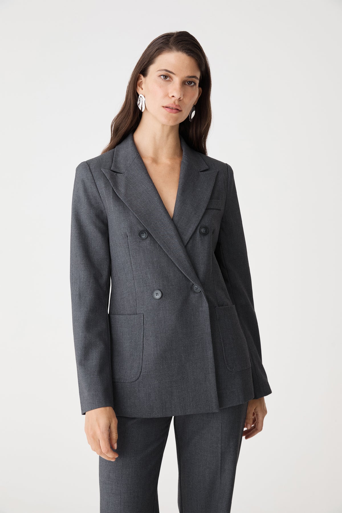 Front close-up of the dark grey blazer showing peak lapels and double-breasted button front