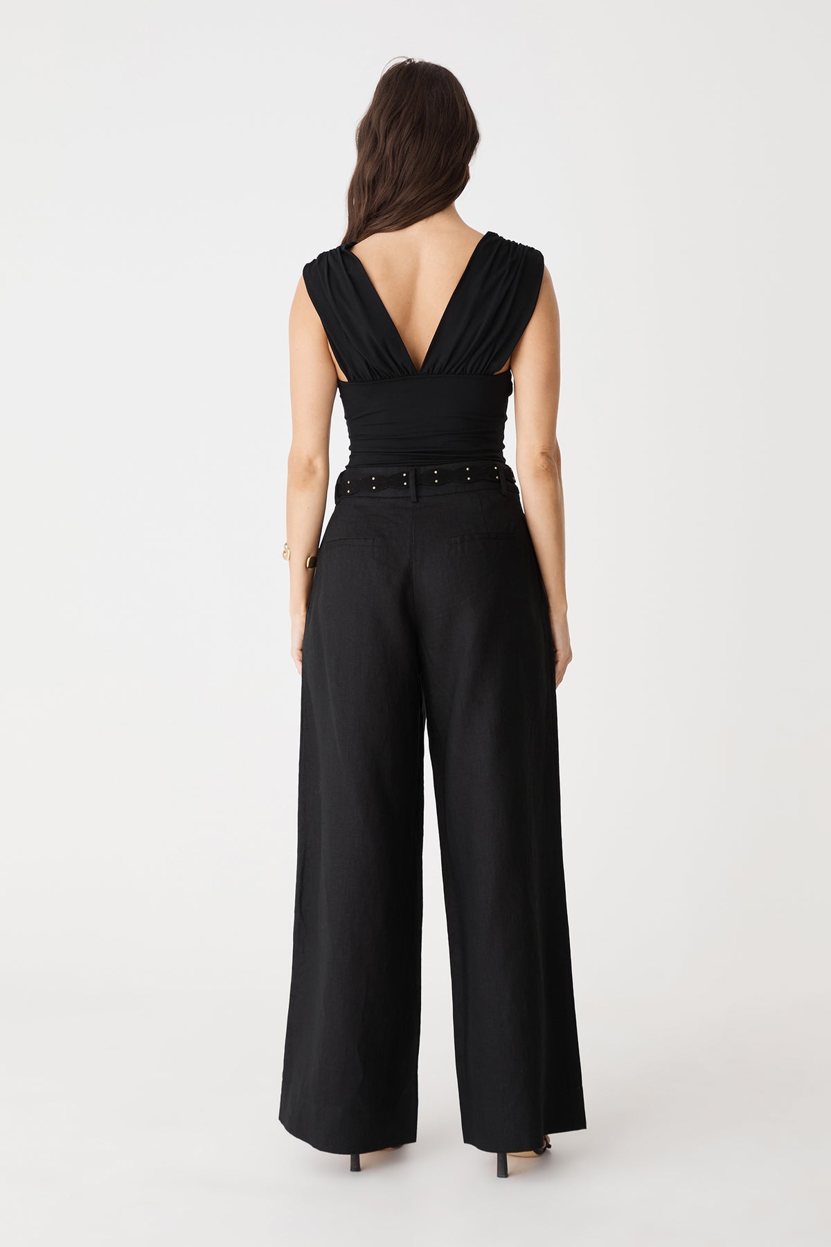 Back view of the black Ami Wide Leg Linen Pants showing faux welt pockets