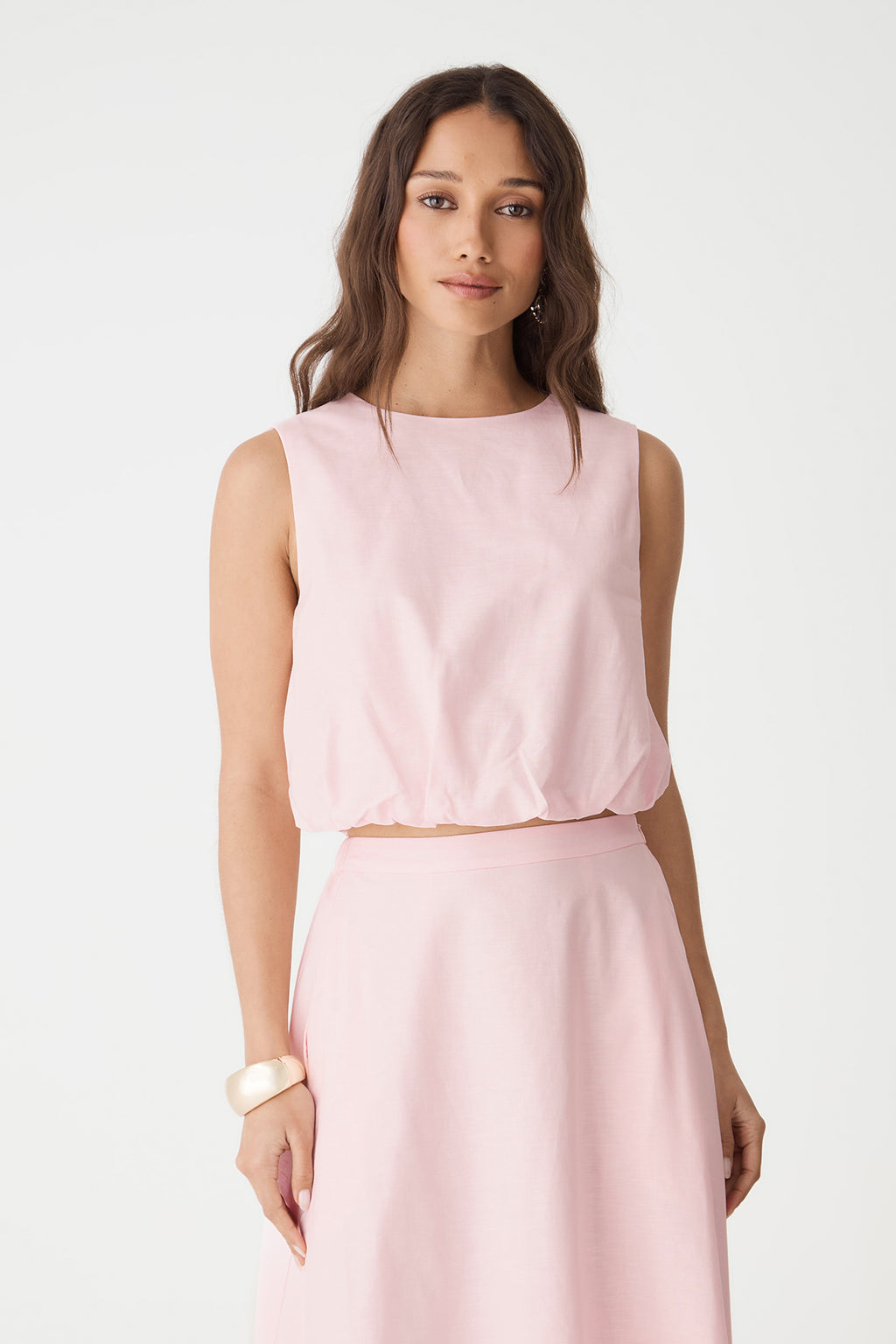 Front close-up of the sleeveless cropped top showing round neckline and elasticated bubble hem
