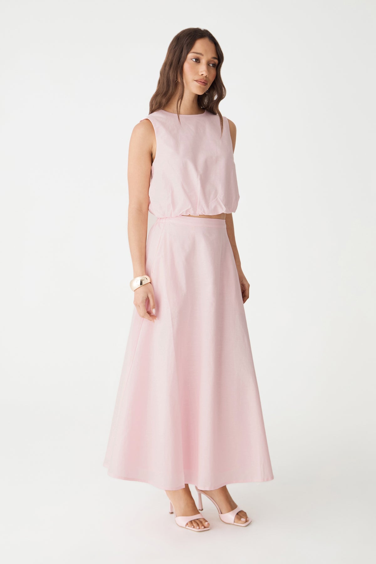 Side-front view of the pink top and matching skirt set