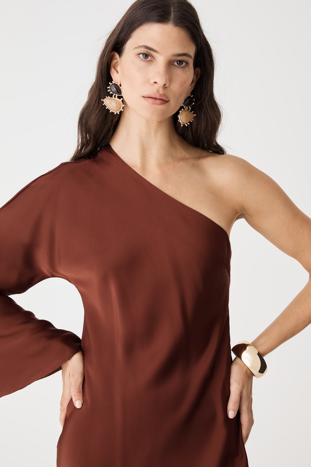 Close-up of bodice and shoulder line, worn with drop earrings and a watch