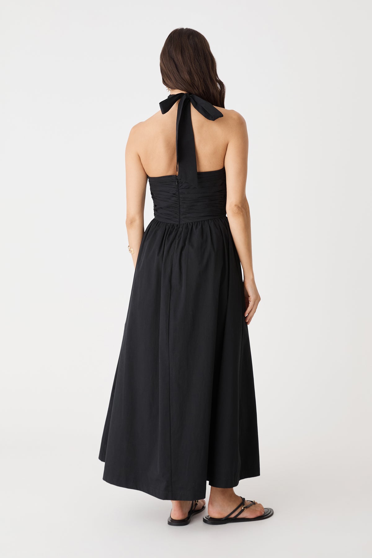 Back view showing open back and neck tie of the black Kayleigh Cotton Halter Dress
