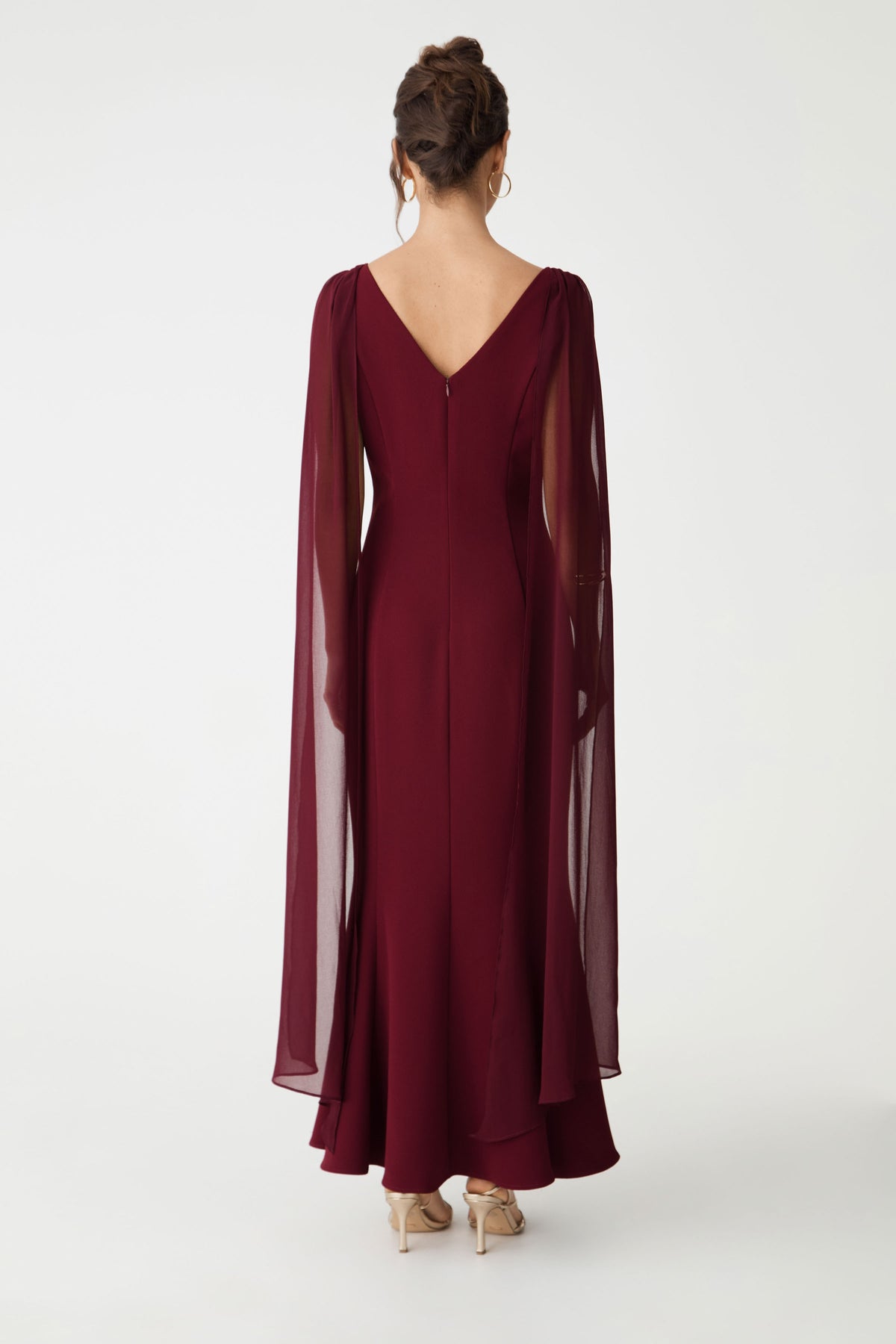 Back view showing the V-neckline and sweeping maxi hem in shiraz