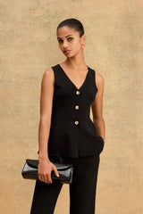 Valerie Button Peplum Knit Top in black, front view with gold-tone buttons, worn with black trousers