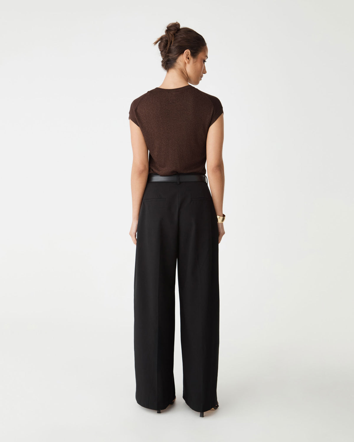 Back view of the Saskia Lurex Knit Top in Fudge with black wide-leg trousers