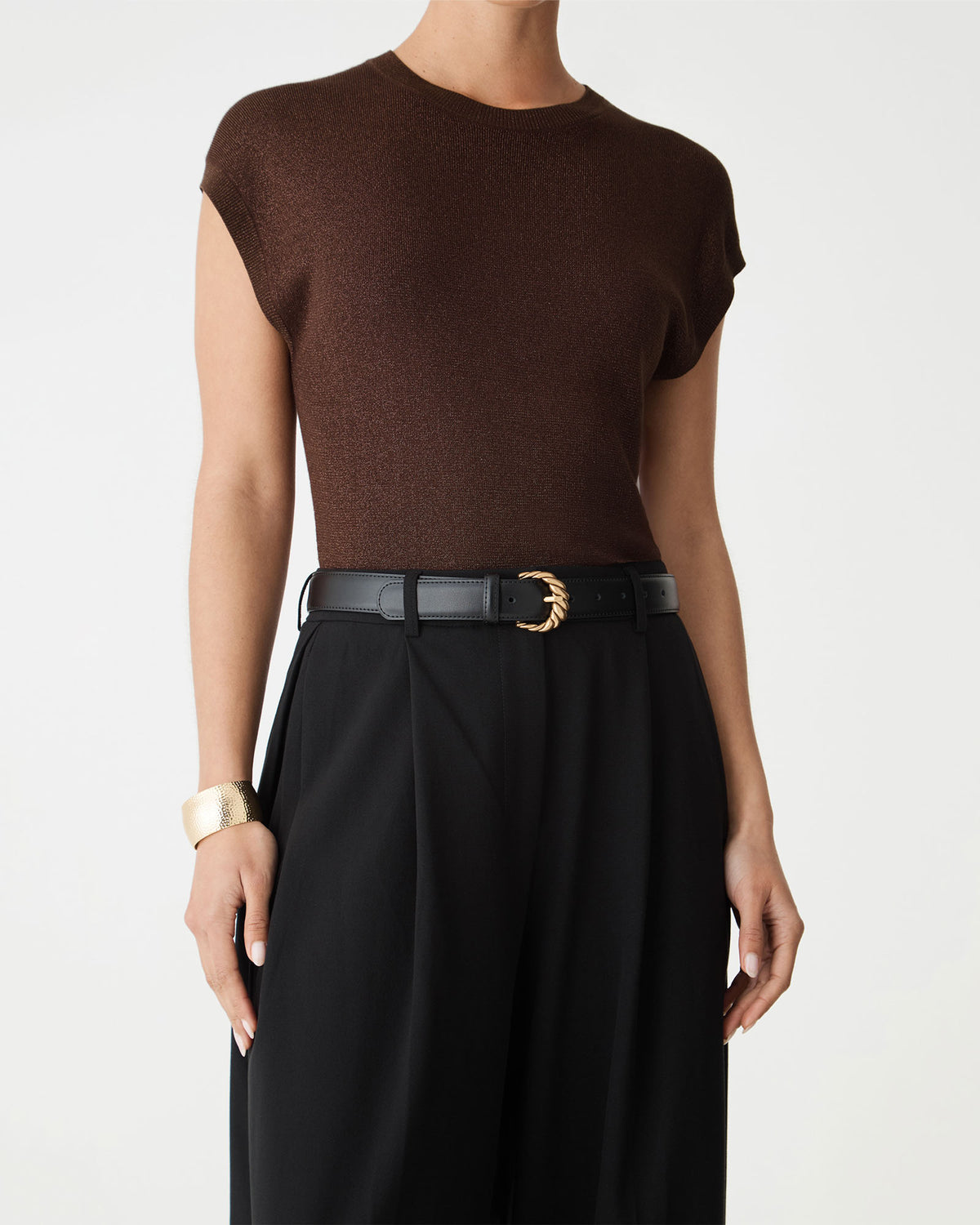 Close-up of the Saskia Lurex Knit Top in Fudge showing ribbed hem and black belt