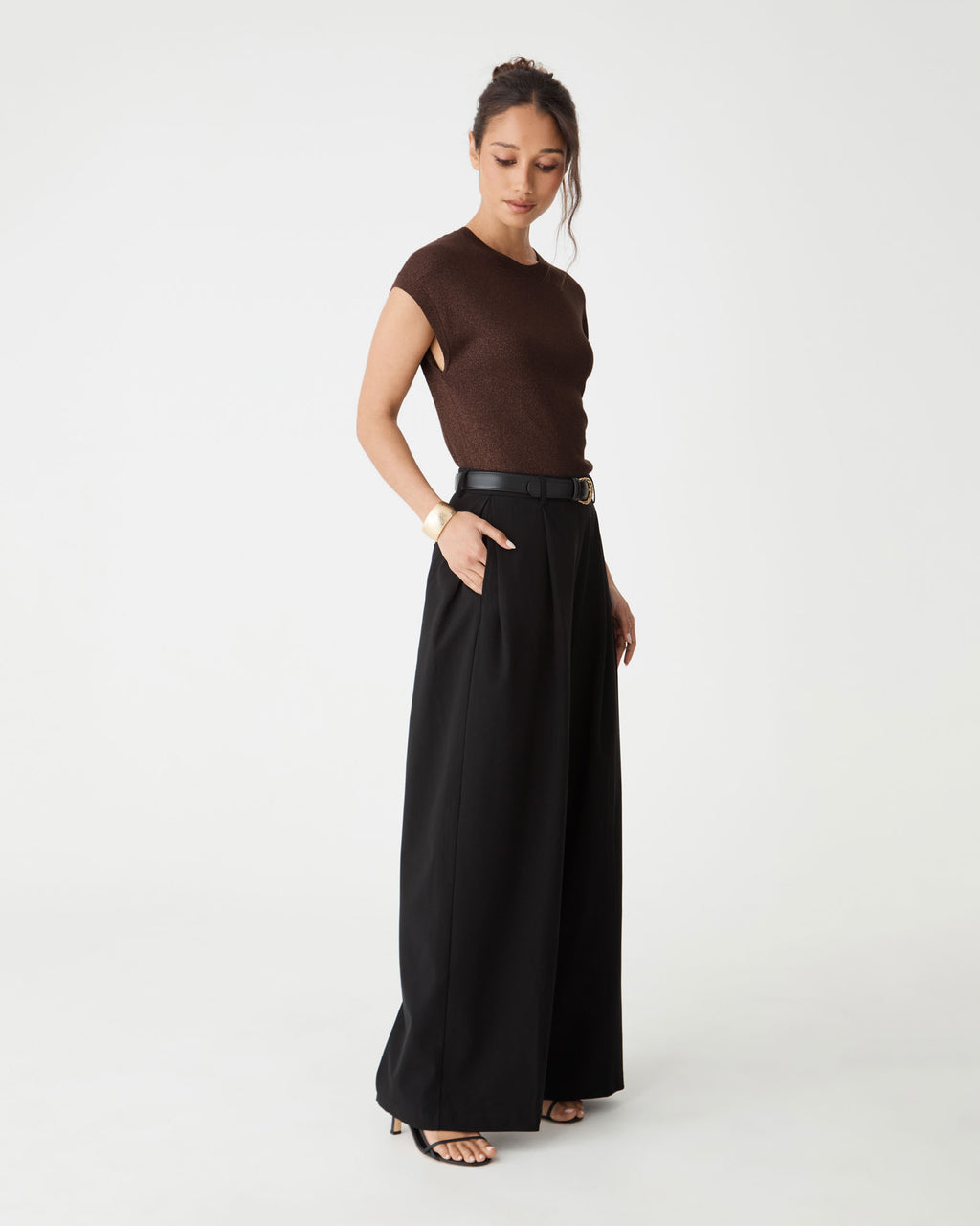 Side view of the Saskia Lurex Knit Top in Fudge with black wide-leg trousers