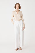 Daphne Pleated Crepe Pants in ivory, front view, worn with a beige shirt tucked in