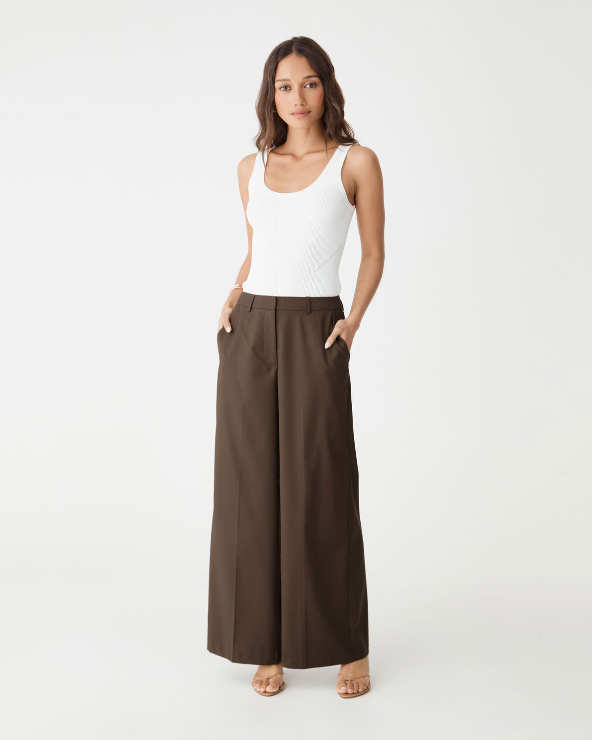 Front view with hands in the side pockets of the cocoa brown wide leg pants