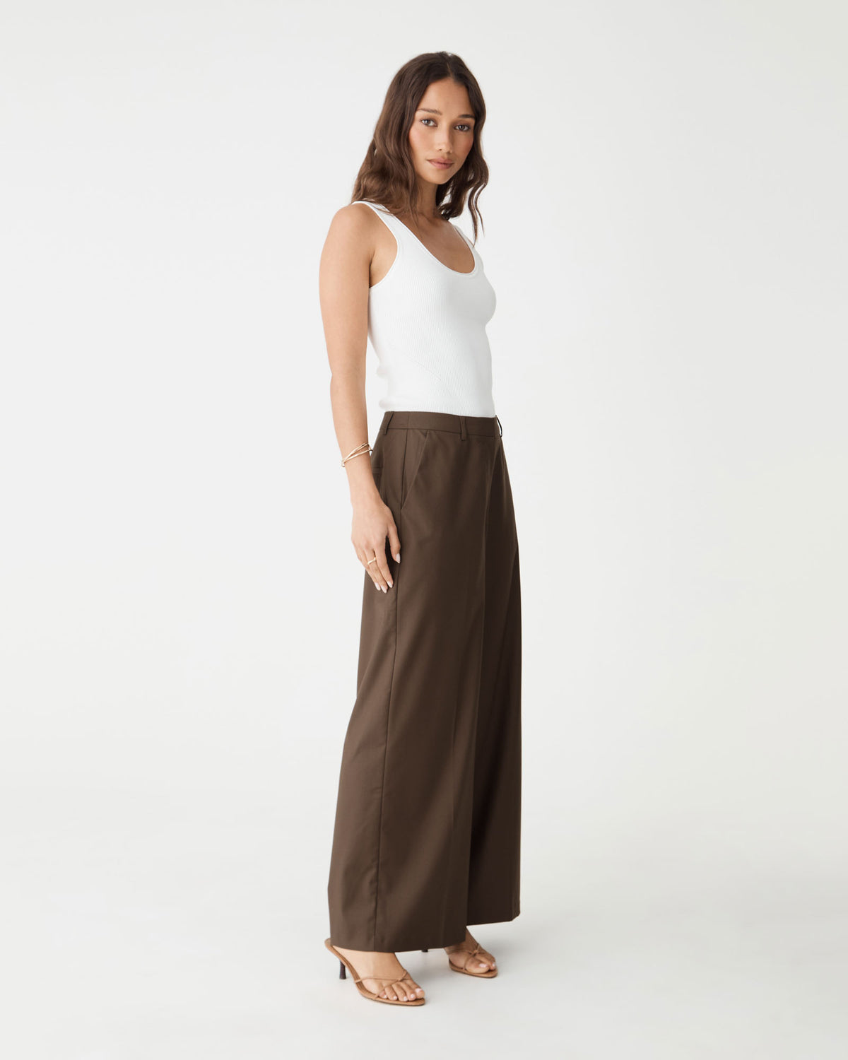 Side view of the cocoa brown wide leg pants with white tank top