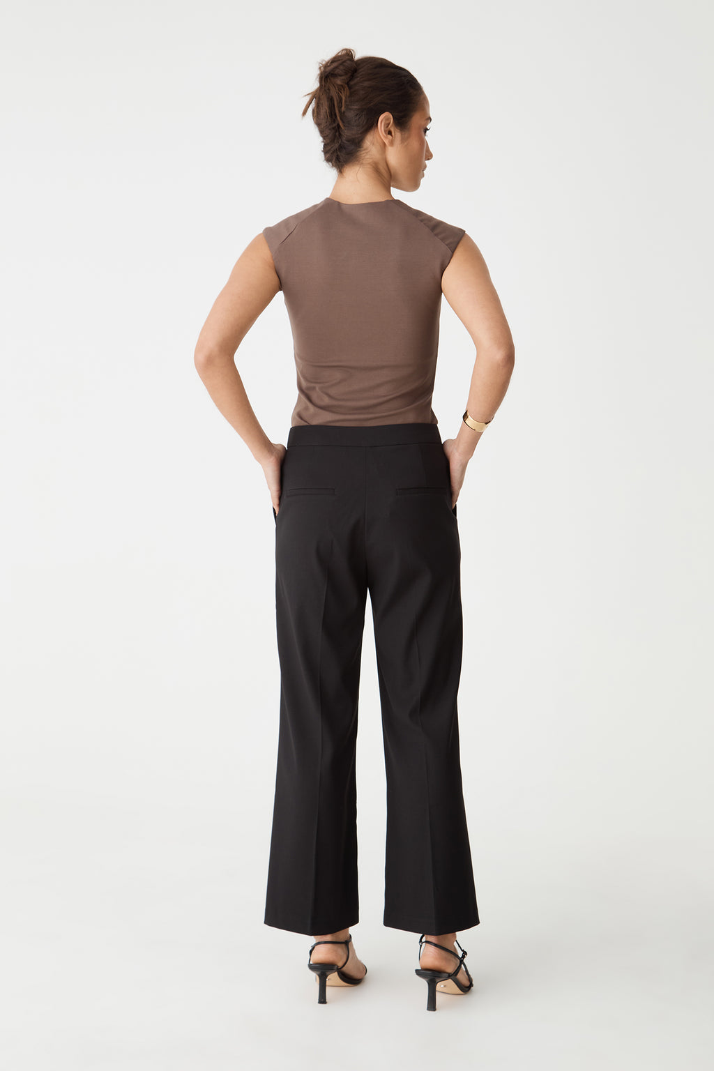 Back view of the black Milan Crop Flare Pants showing dual back welt pockets