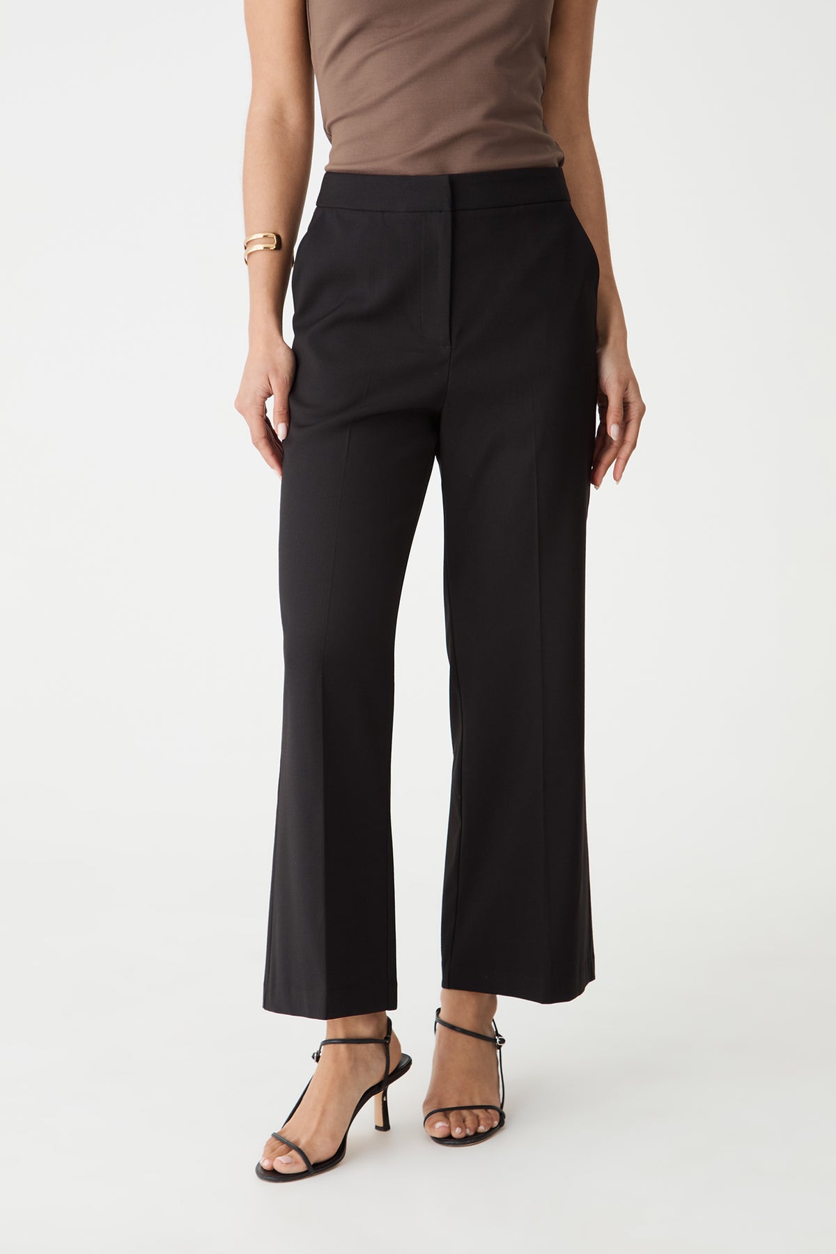 Milan Crop Flare Pants in black, front view with concealed zip fly, worn with a brown top