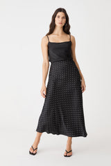 Courtney Bias Satin Skirt in black and white dot, front view worn with a black camisole