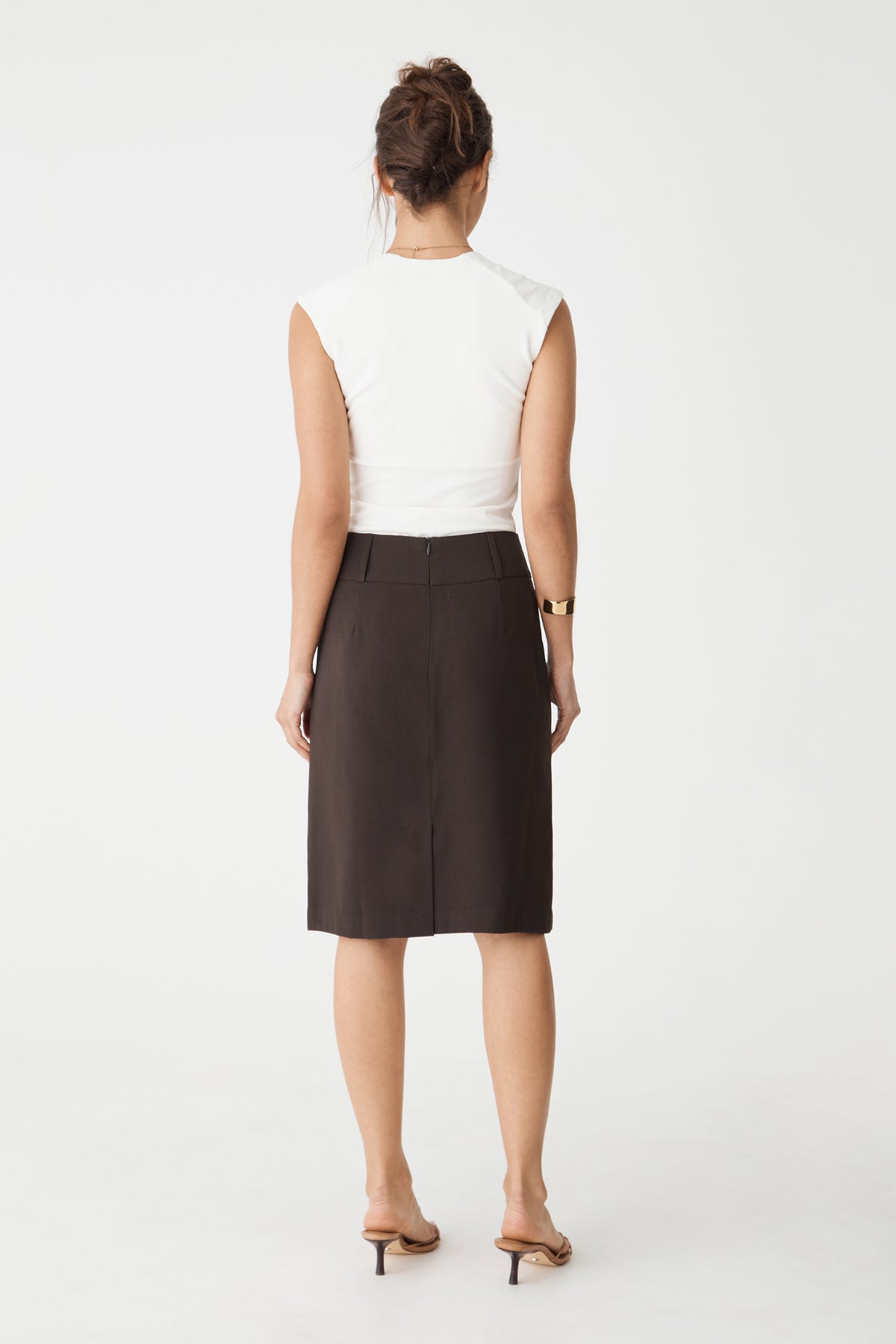 Back view showing centre-back seam and vent of the chocolate skirt