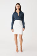 Lydia Short Straight Skirt in white, front view, worn with a navy spotted shirt and heels