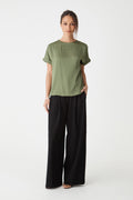 Cameron Satin Tee in soft khaki, front view worn with black wide-leg trousers