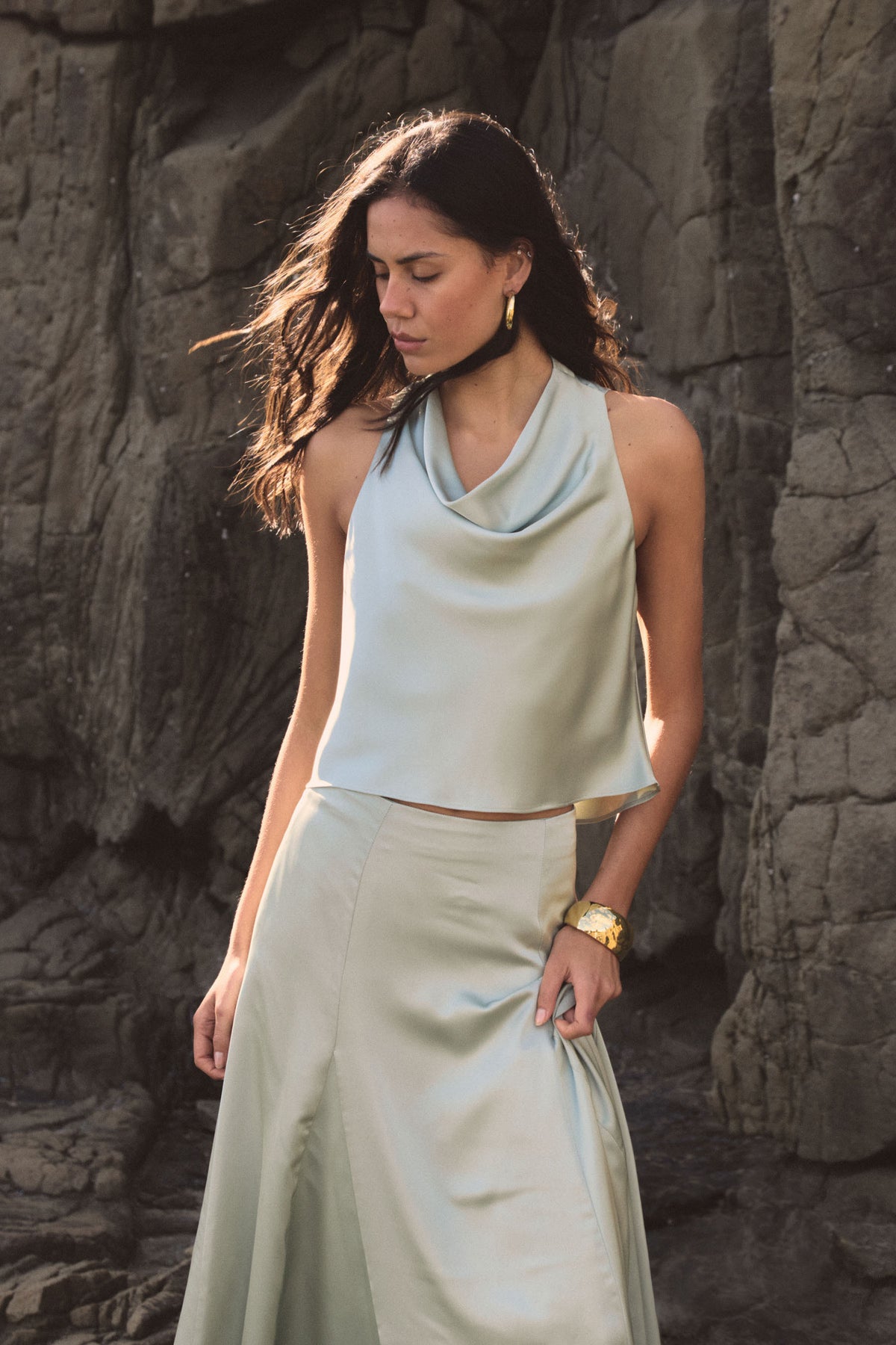 Freya Satin Cowl Top in pistachio, side view showing draped cowl neckline and relaxed armhole, worn with matching skirt