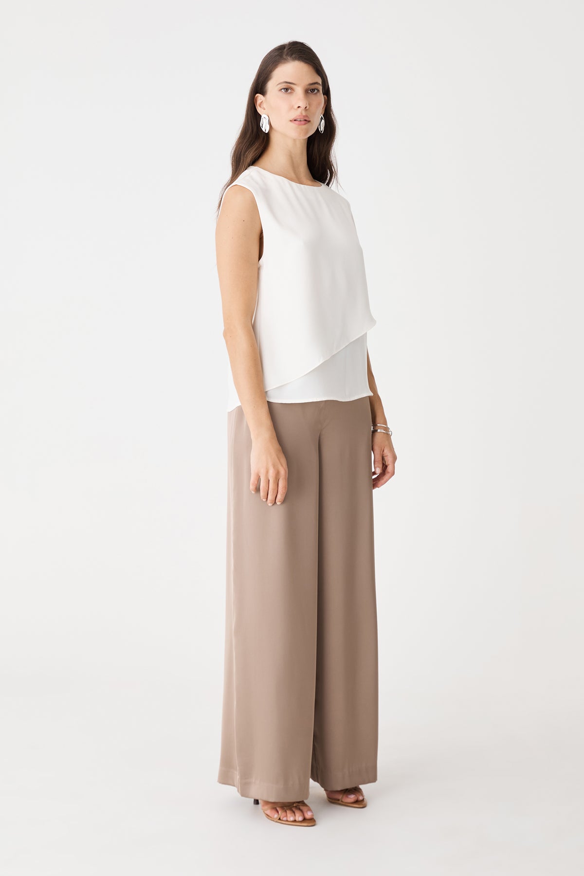 Angled view of the ivory top showing the bare shoulder and round neckline