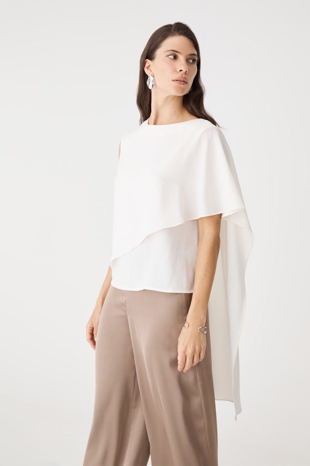 Close side view of the ivory cape overlay falling over one shoulder