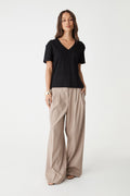 May V-Neck Cotton T-Shirt in black, front view worn untucked with beige wide-leg pants