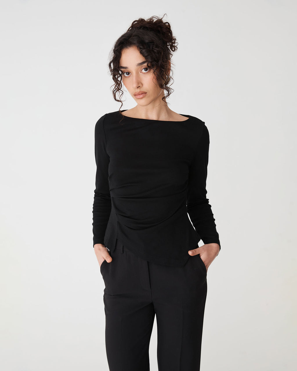 Calia Asymmetric Knit Top in black — close-up view