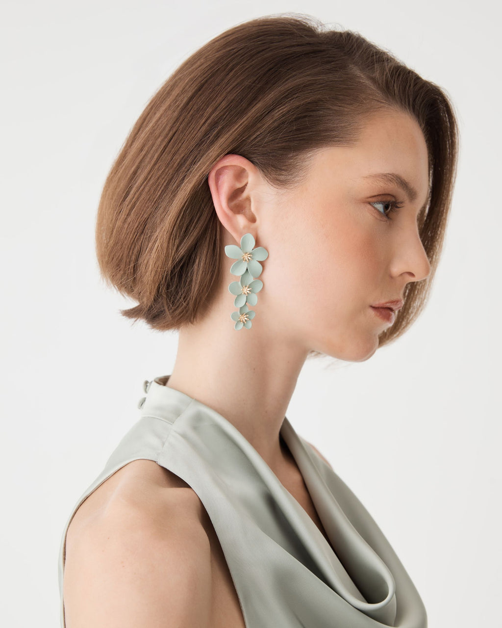 Side profile view of the aqua floral drop earring showing graduated flower sizes