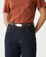 Lumi Croc Effect Belt in Tiramisu, close-up of gold-tone buckle worn with dark jeans and rust tee